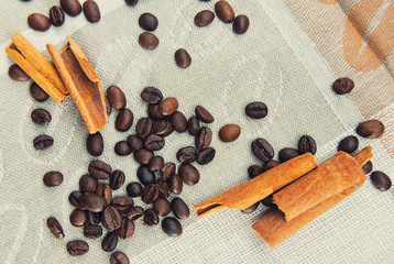 Coffee grains scattered on a patterned tablecloth