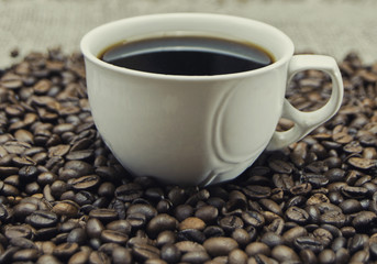 cup of coffee standing on the grains