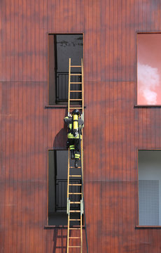 firefighter with a long ladder with the oxygen cylinder while en