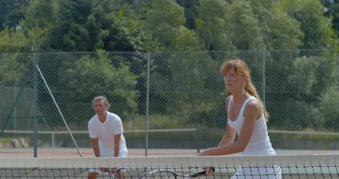 Super slow motion female tennis player hitting the ball during a game