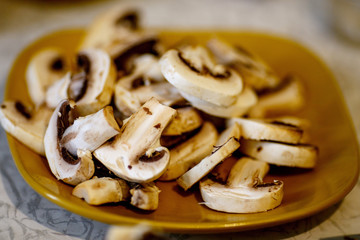 sliced champignons on a yellow plate