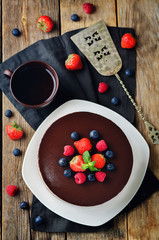 Naklejka na ściany i meble Triple chocolate mousse cake decorated with fresh berries