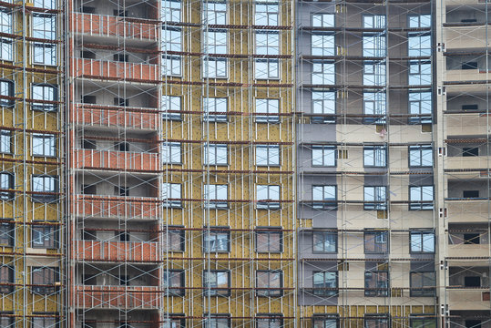 Construction of high-rise building with scaffolds