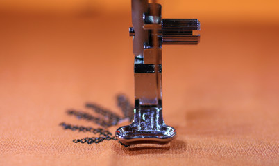 movement of the sewing machine with a steel needle and the embro