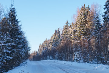 Winter landscape with a road in a frosty day