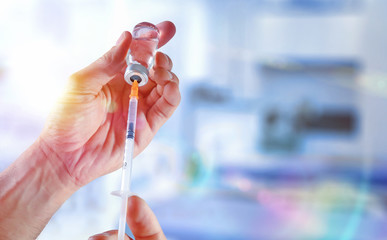 Hands with vial and syringe medication and vaccination concept