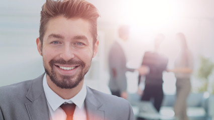 Handsome Business man in an office with blurred  background