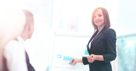 Businesswoman asking question during her colleagues presentation