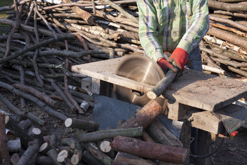 Builder Using Saw to Cut Wood in the village