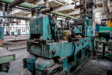 Fototapeta na wymiar Abandoned tire factory with rusted machine tools