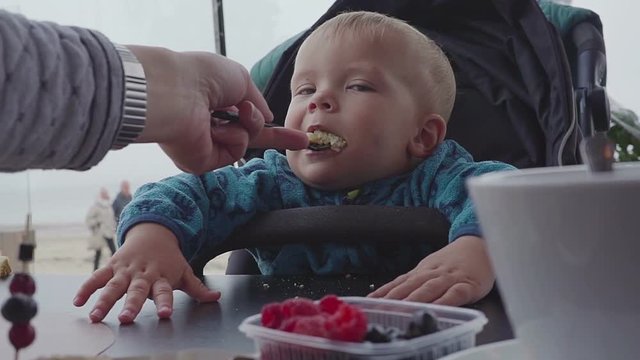 Children and food, baby eating pancakes in a restaurant