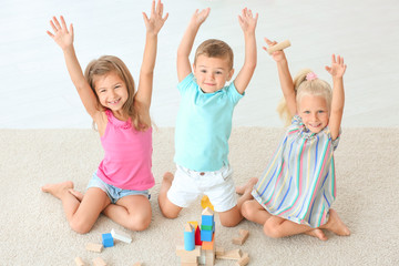 Fototapeta na wymiar Cute children playing with blocks indoor