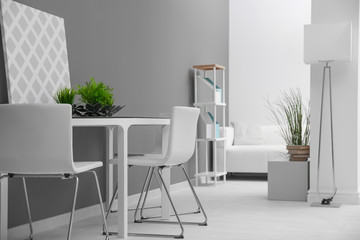 Modern room interior with white chairs and table