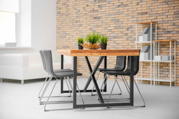Modern room interior with wooden table
