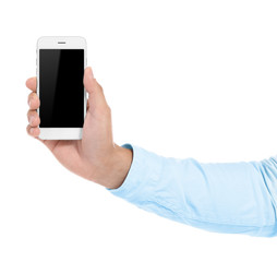 Hand of young man with mobile phone on white background