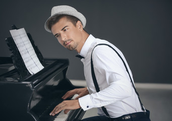 Young man playing piano indoors
