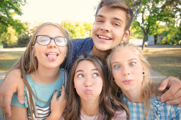Happy teenagers posing outdoors