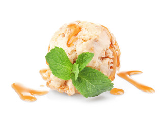 Scoop of ice cream with caramel topping and mint, isolated on white