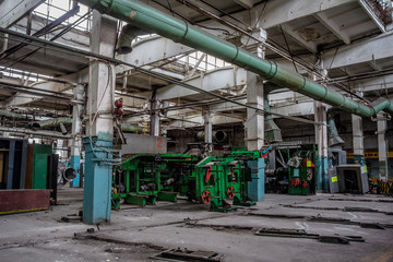 Fototapeta na wymiar Abandoned old tire factory with rusted machine tools