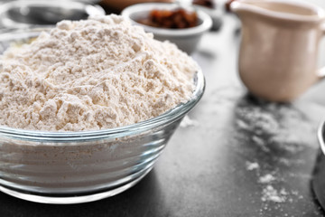 Bowl with flour on table