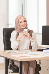 Muslim Businesswoman In Office Answering The Phone