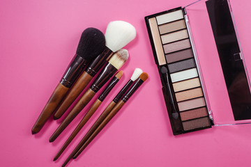 Set of colorful cosmetics on pink background