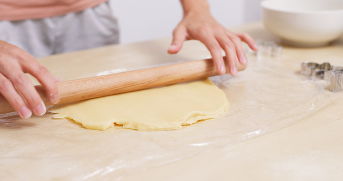 Chef rolling dough with rolling pin