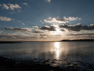 beautiful sunset over harbour coast sea bay clouds silhouette landscape