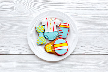 baby shower with cookies for celebration on white wooden background top view mock up