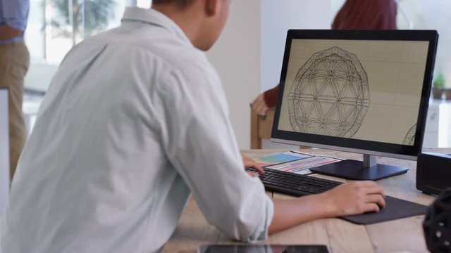 Designer working, creating 3D printed objects from computer software