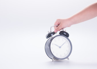 alarm clock with hand. alarm clock with hand on the background.