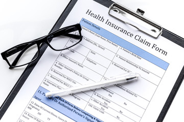 Take out health insurance. Document, pad, pen on white background top view