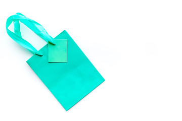 Turquoise bright shopping bag on white background top view copyspace