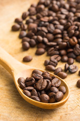 Coffee beans whit wooden spoon on wood