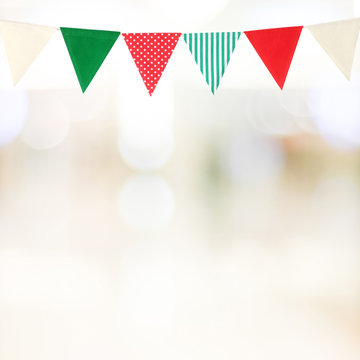 Christmas and new year colorful bunting party flags hanging over blur festive bokeh light backgrounds, banner, with copy space for text