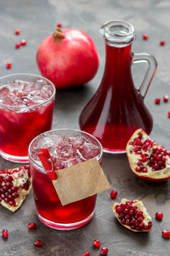 Pomegranat juice with ice, fruit slices and paper for text