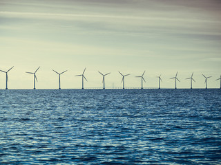 Wind turbines power generator farm along coast sea