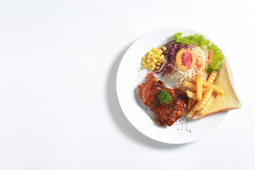 Top view of grilled chicken fillet with fresh vegetables on white plate background.