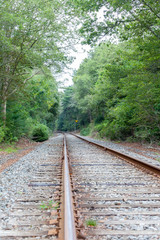 Fototapeta premium Train Rail Tracks Leading to Curve to the Left