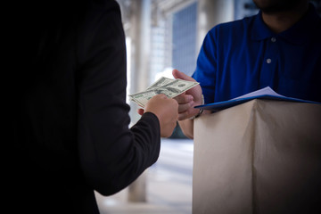 Delivery man receive paying cash payment Package courier parcel, people hand giving courier service payment.  receiving delivery package postal box, delivery man service cash payment concept.