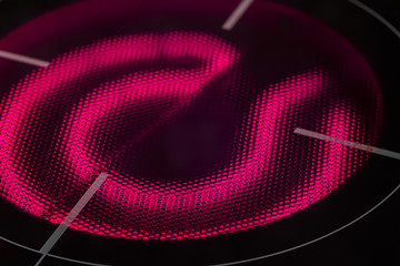 The red-hot red-burner induction hob close up.