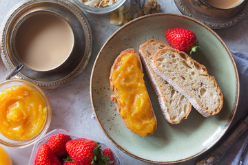 Traditional european breakfast. Bread, jam and berries on the plate