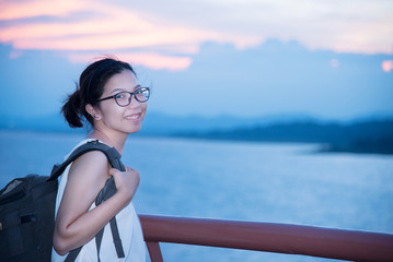 Happy Asian traveller glasses woman smiling.