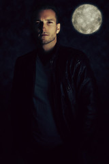 A vampire story. Handsome man wearing a leather jacket 