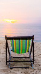 chair beach with sunset and blue sky background.vintage tone. Travel concept.