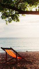 chair beach with sunset and blue sky background.vintage tone. Travel concept.