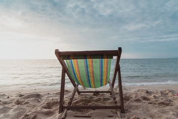 chair beach with sunset and blue sky background.vintage tone. Travel concept.