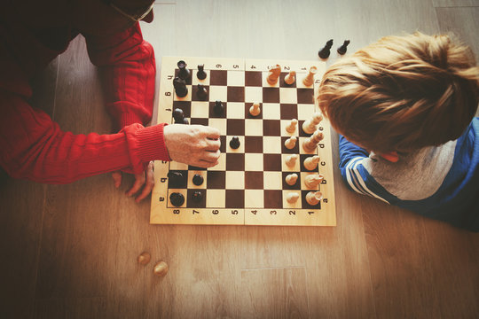 Teacher And Kid Play Chess In School