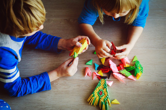 kids making origami crafts with paper