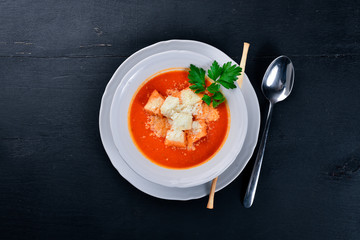 Tomato soup. On a wooden surface. Top view. Free space for your text.